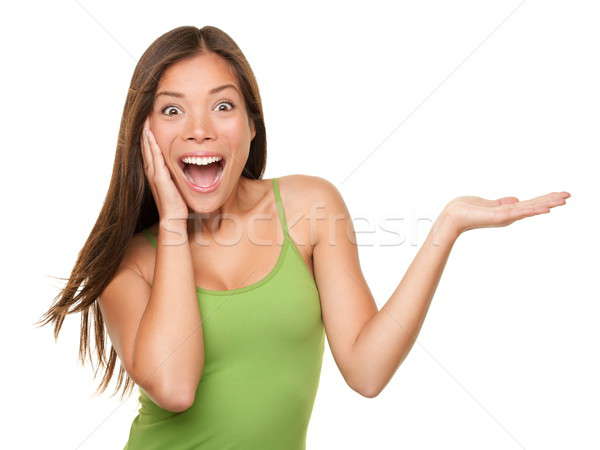 Stock photo: Surprised woman showing product