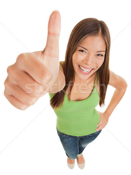 Fun portrait of a woman giving a thumbs up Stock photo © Ariwasabi