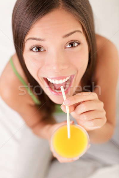 Woman drinking orange juice Stock photo © Ariwasabi