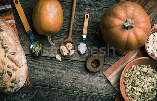 Rustic pumpkins and bread with seeds on wood Stock photo © Arsgera