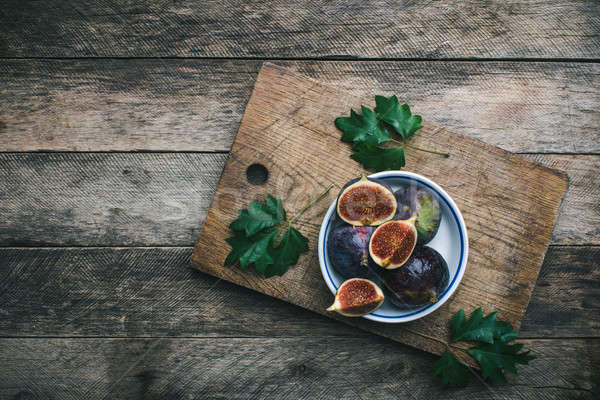 Stock photo: Ripe Figs on cutting board and wooden table