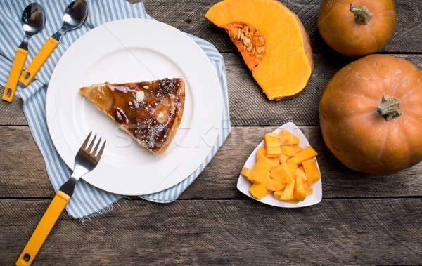 Piece of pie and Pumpkin slices on wood Stock photo © Arsgera