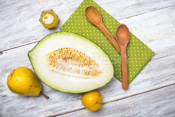 Melon with honey and two yellow pears on wood Stock photo © Arsgera