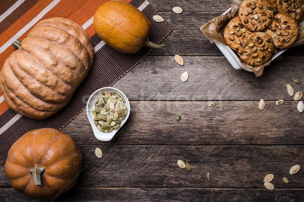 Pumpkins with seeds and  cookies on wood in Rustic style Stock photo © Arsgera
