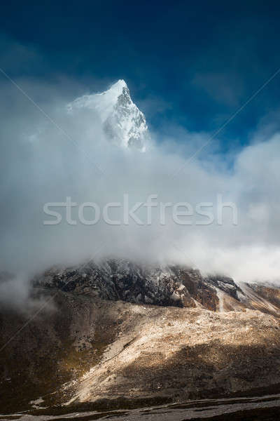 Cholatse 6335 m mountain summit hidden in clouds Stock photo © Arsgera