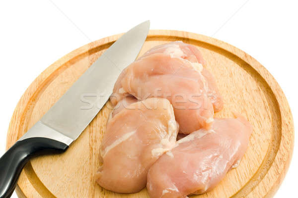 Stock photo: Chicken fillet and knife on hardboard isolated