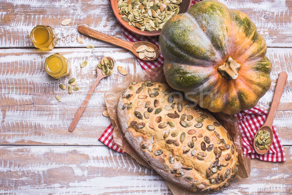 Bread with seeds and pumpkin on wooden table in rustic style Stock photo © Arsgera