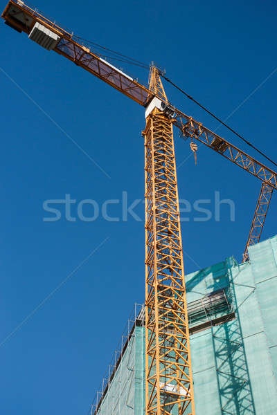 Construction site: crane and unfinished buiding Stock photo © Arsgera