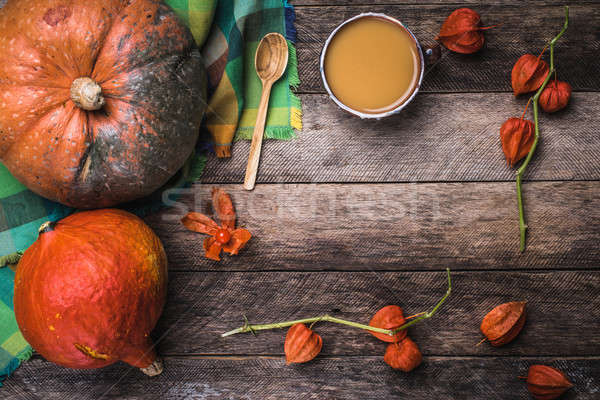Rustic style pumpkins, soup and ground cherry branches on wood Stock photo © Arsgera