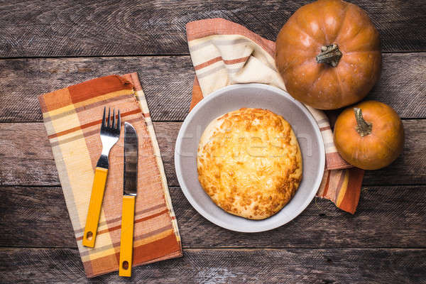 Rustic style pumpkins and flat cake on wooden table Stock photo © Arsgera