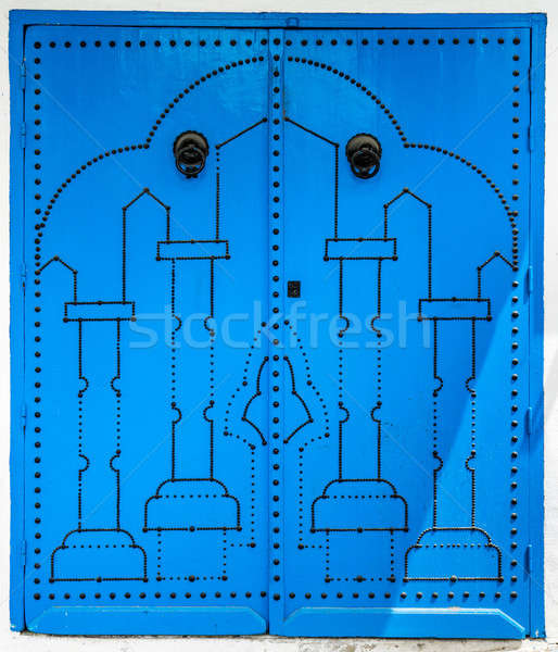 Blue door with traditional ornament as symbol of Sidi Bou Said Stock photo © Arsgera