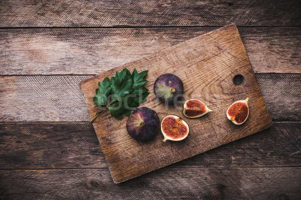 Tasty Figs on chopping board and wooden table Stock photo © Arsgera
