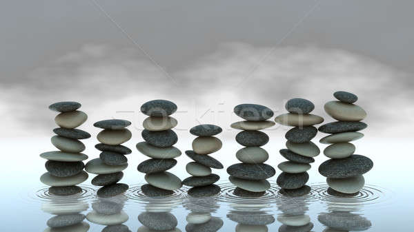 Group of Pebble stacks on water level Stock photo © Arsgera