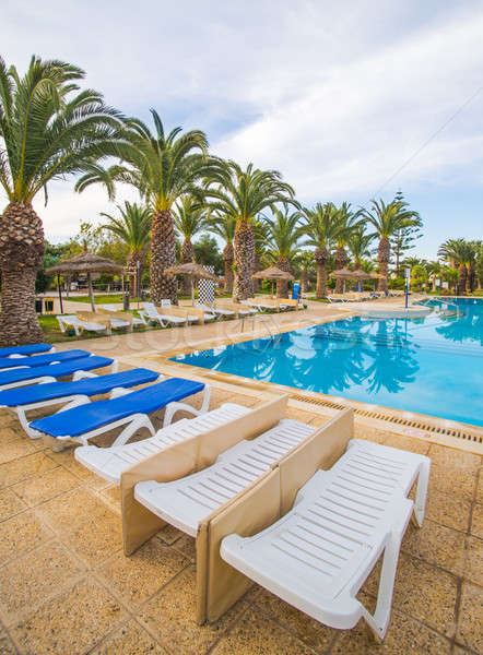 swimming pool and deck chairs at luxury resort Stock photo © Arsgera