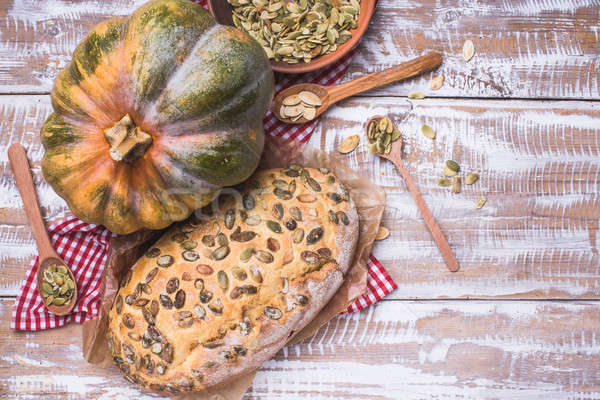 Rustic style baked bread with seeds and pumpkin on wood Stock photo © Arsgera