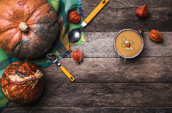 Rustic style pumpkins and soup with seeds and ground cherry on w Stock photo © Arsgera