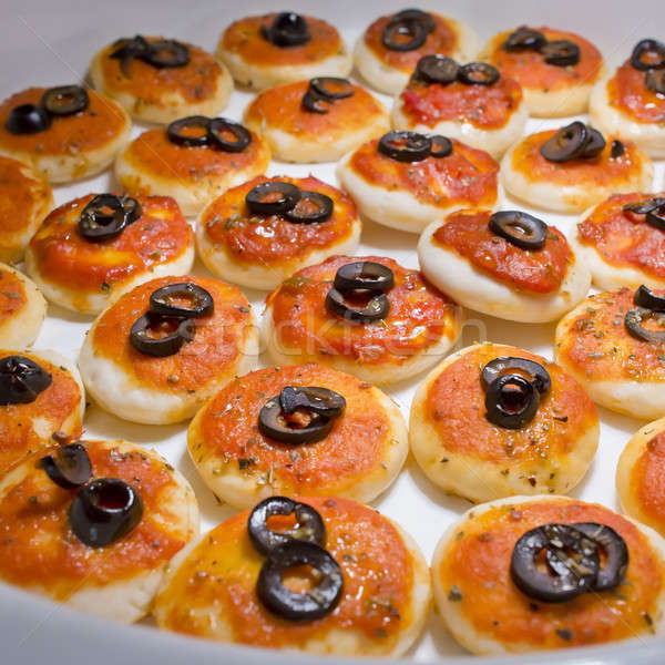 round meat pies with topping black olive sliced on buffet line Stock photo © art9858