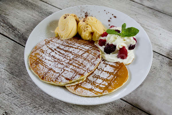 Stock photo: pancakes with vanila ice cream, whipping cream and icezing