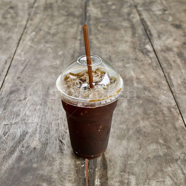 Stock photo: Delicious ice coffee americano on old wood table.
