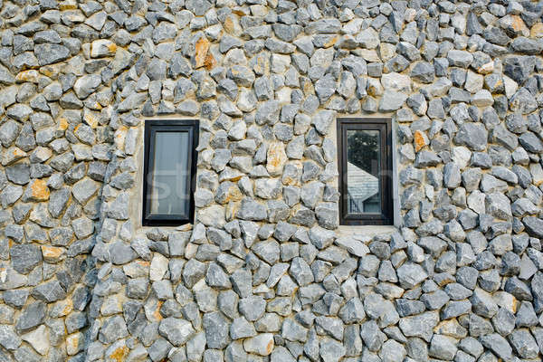 Rock wall with two narrow windows Stock photo © art9858