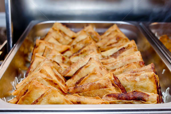Triangle Crispy Puff pastry in metal tray on buffet line Stock photo © art9858