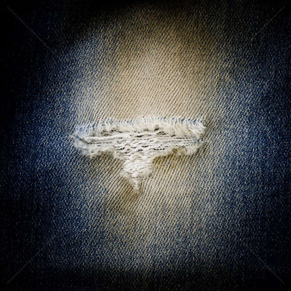 blue jean texture with a hole and threads showing Stock photo © art9858