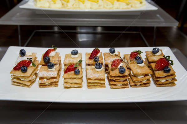 Stack of crispy pancake with banana slice topping of strawberry, Stock photo © art9858