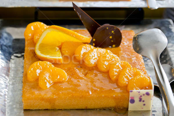 Orange and a piece of orange cake with chocolate topping - finge Stock photo © art9858