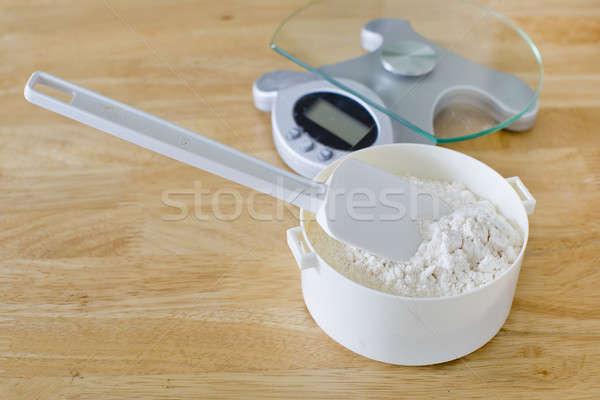 Bread flour in white bowl with rubber scraper and scale on wood  Stock photo © art9858