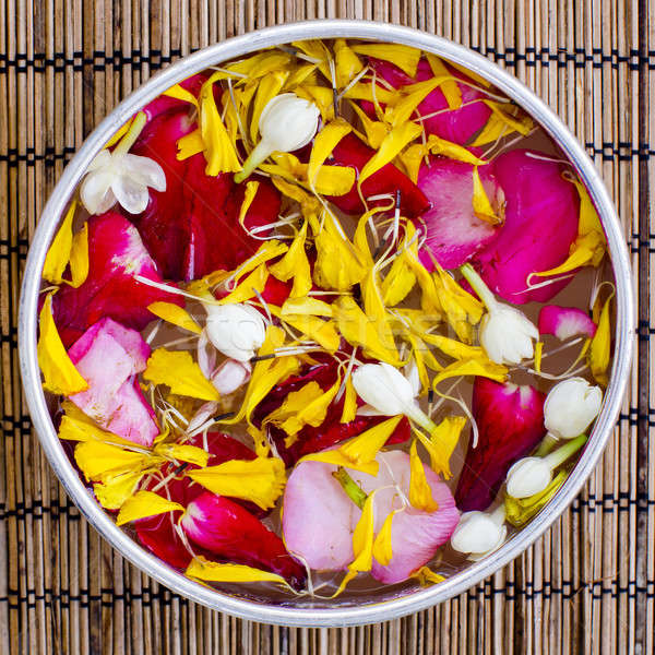 Water with jasmine and roses corolla in bowl Stock photo © art9858