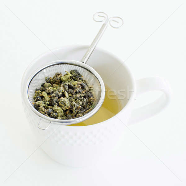 Herbal tea in a glass cup, metal sieve with dry herbal tea on a  Stock photo © art9858