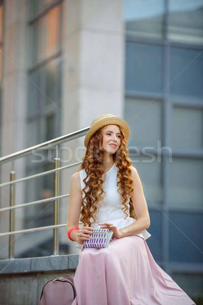 Portrait of a beautiful european woman sitting om steps Stock photo © artfotodima