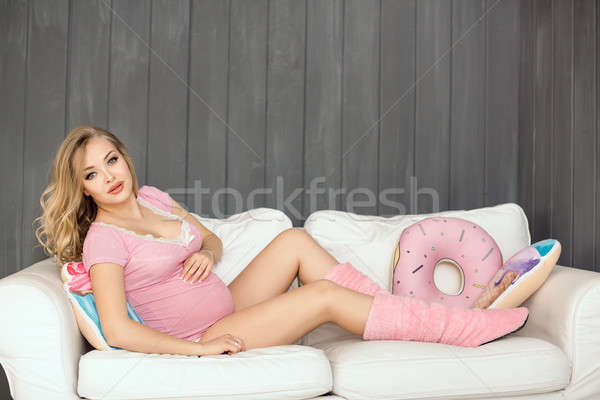 Pregnant woman with toys of ice cream posing indoors at home. Heath care and food consept. Stock photo © artfotodima