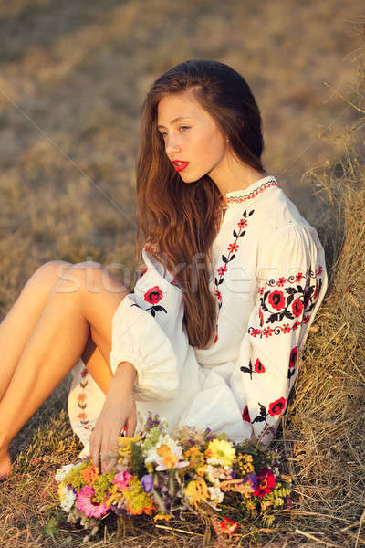 Beautiful girl in meadow in national suite Stock photo © artfotodima