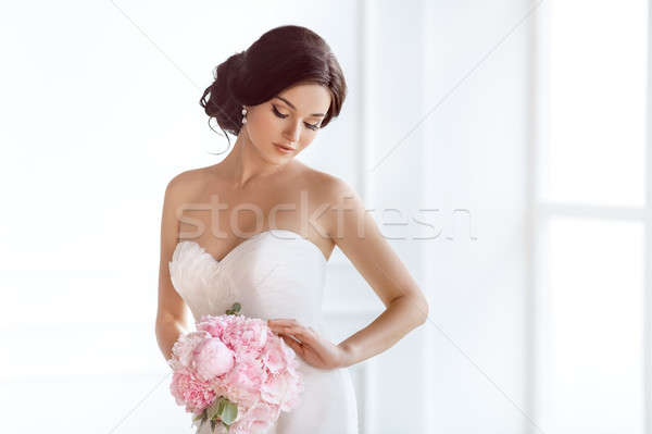 Beautiful bride. Wedding hairstyle make-up luxury fashion dress and bouquet of flowers. Stock photo © artfotodima