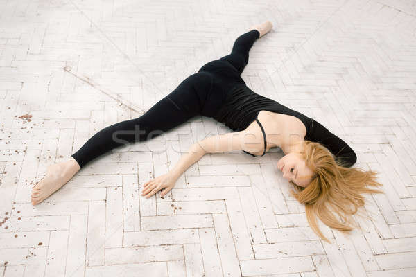 Young attractive female fitness woman performing a twine Stock photo © artfotodima