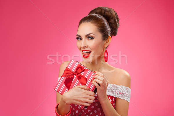 Excited Woman Holding Gift Box. Pin-up retro style. Stock photo © artfotodima