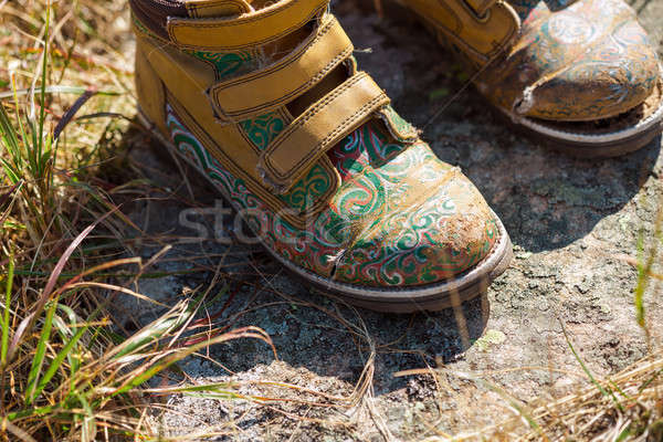 Old tourists boots on stone near mountain stream Stock photo © artfotodima