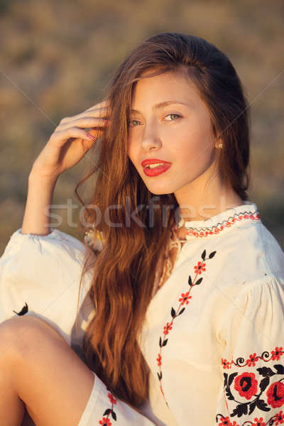 Portrait of beautiful girl in meadow in national suite Stock photo © artfotodima