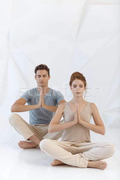 Fiatal pér jóga póz gyakorol jóga bent fehér Stock fotó © artfotodima