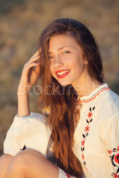 Stock photo: Portrait of beautiful girl in meadow in national suite