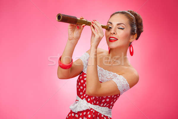  Happy Woman Holding Telescope. Pin-Up Retro style. Stock photo © artfotodima