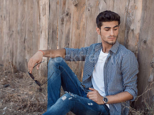 Przystojny młody człowiek odkryty portret zarost posiedzenia Zdjęcia stock © artfotodima