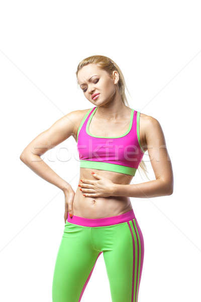 Fitness woman having pain in stomach over white Stock photo © artfotodima