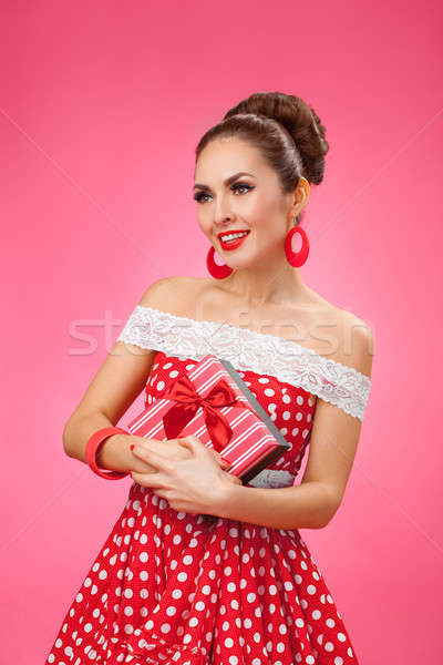  Happy Woman Holding Gift Box. Pin-up retro style. Stock photo © artfotodima