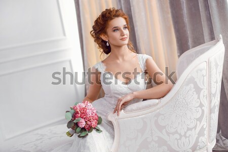 Stunning young bride holding bouquet Stock photo © artfotodima
