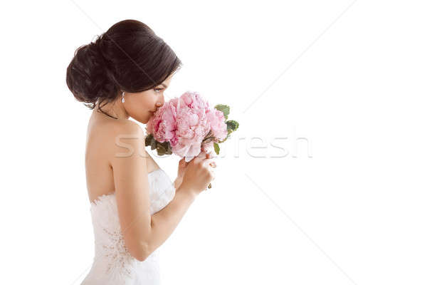 Beautiful bride with her flowers. Wedding hairstyle make-up luxury fashion dress and bouquet Stock photo © artfotodima