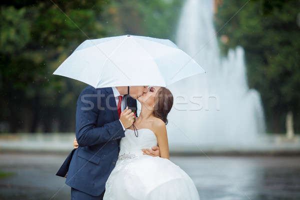 Happy Bride and groom at wedding walk white umbrella Stock photo © artfotodima