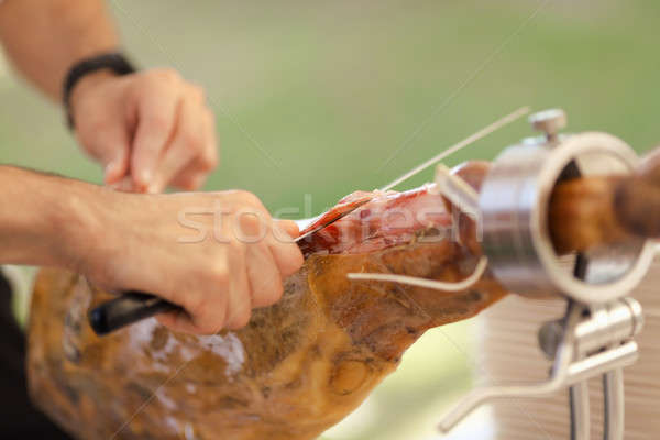 Jamon. Traditional Spanish ham on black close up. Slicing Hamon iberico Stock photo © artfotodima