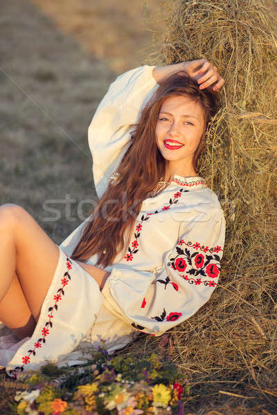 Beautiful girl in meadow in national suite Stock photo © artfotodima